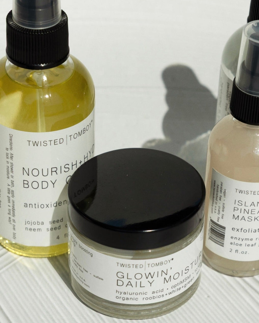 Collection of skincare products on a textured white surface