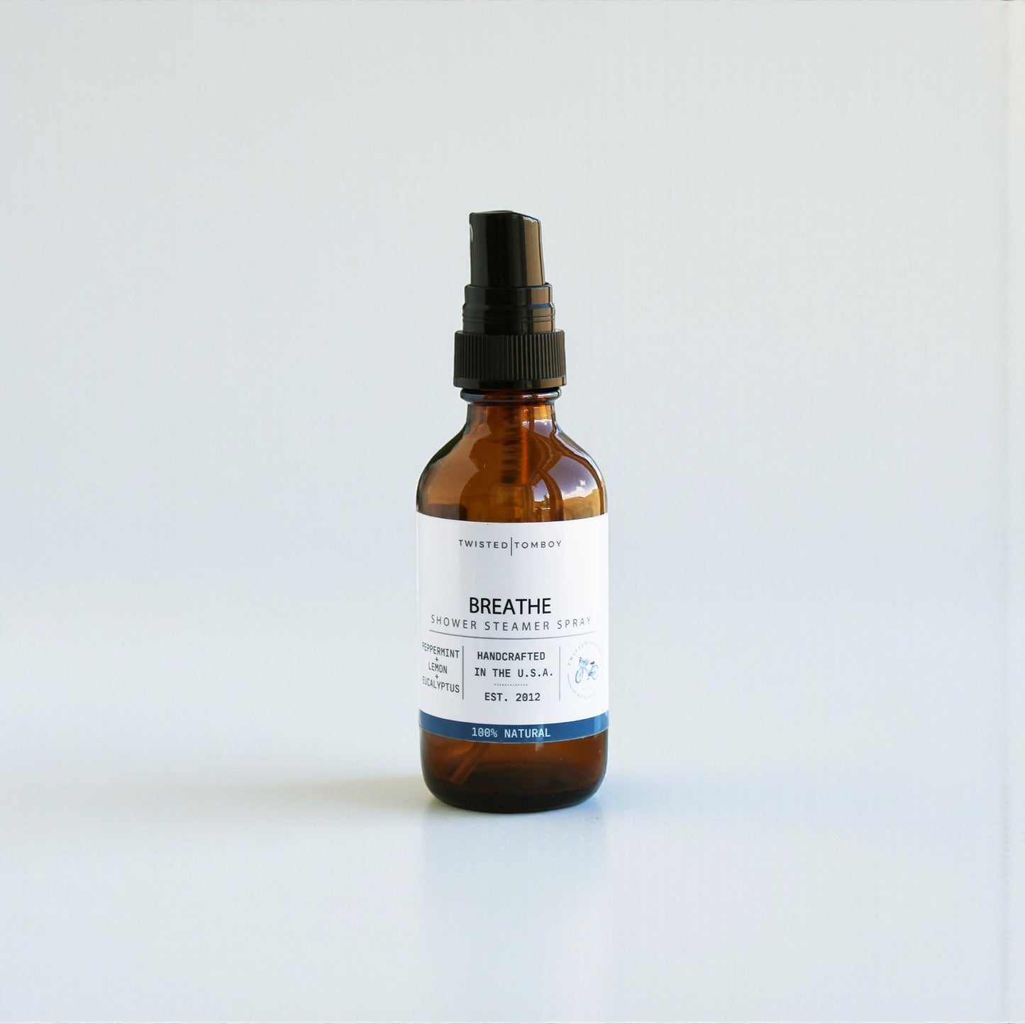 Brown spray bottle labeled 'Breathe' on a white background