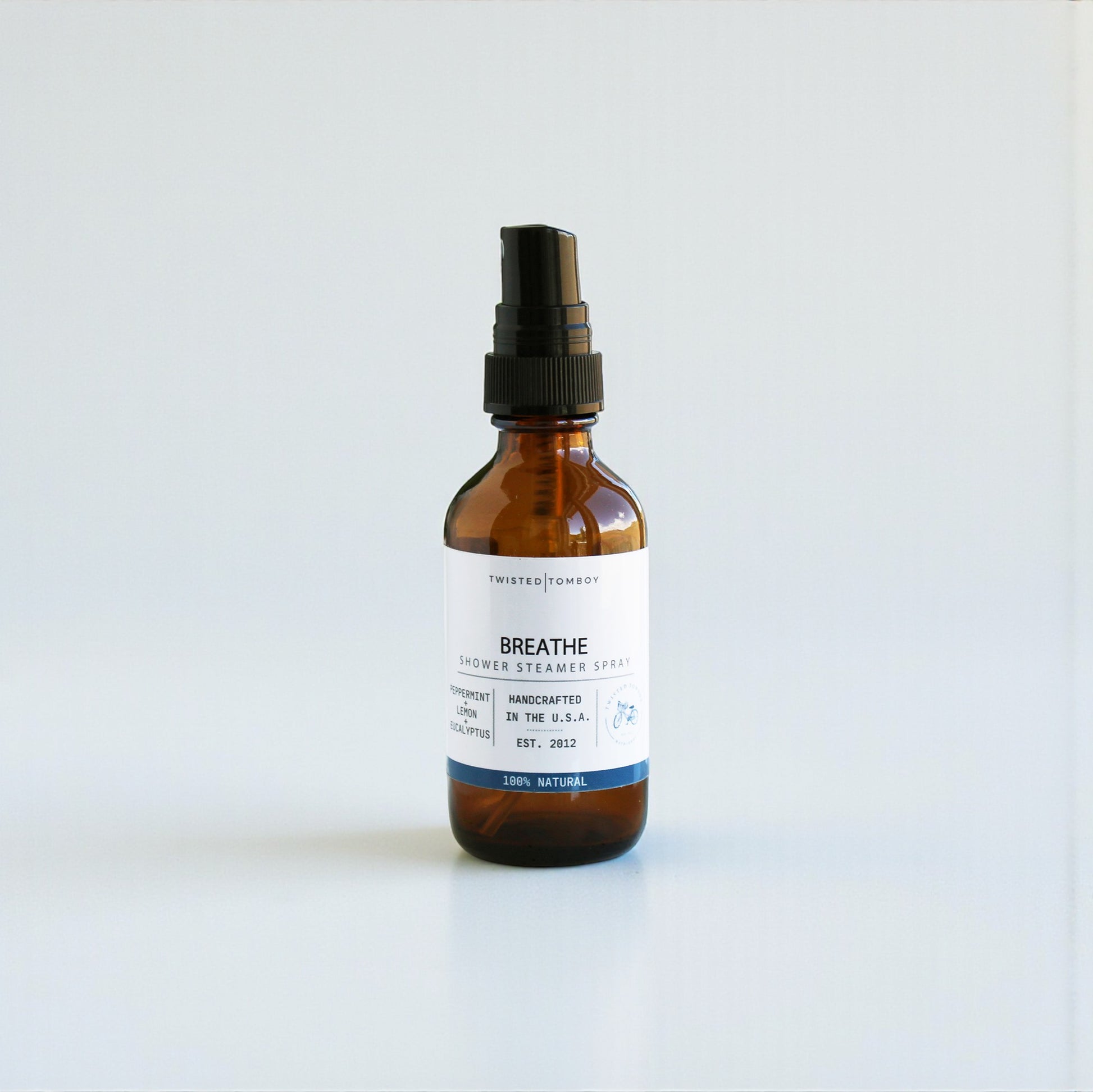 Brown spray bottle labeled 'Breathe' on a white background