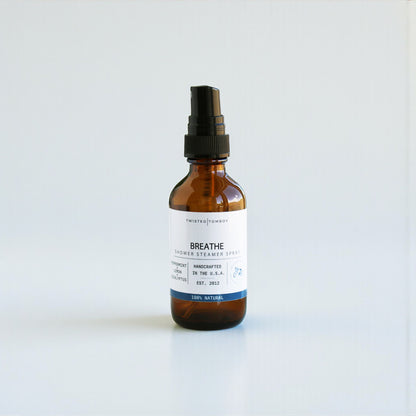 Brown spray bottle labeled 'Breathe' on a white background