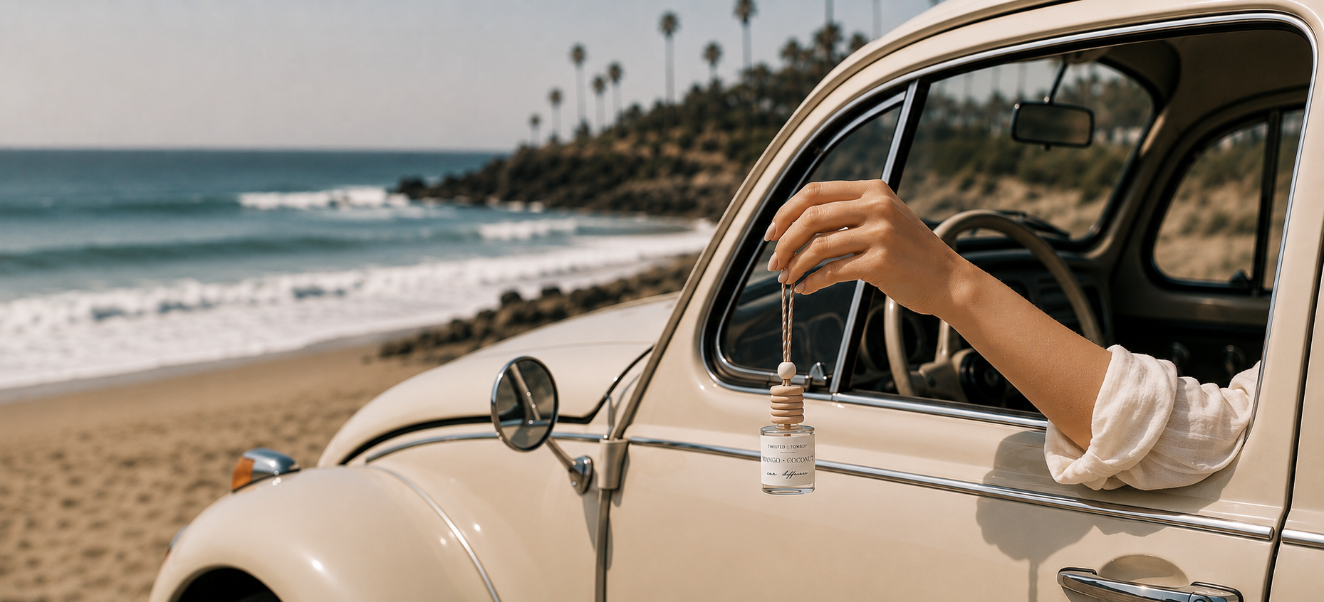 A person's arm extends out of vintage car window holding asmall bottle with a dropper and a wooden stopper. 