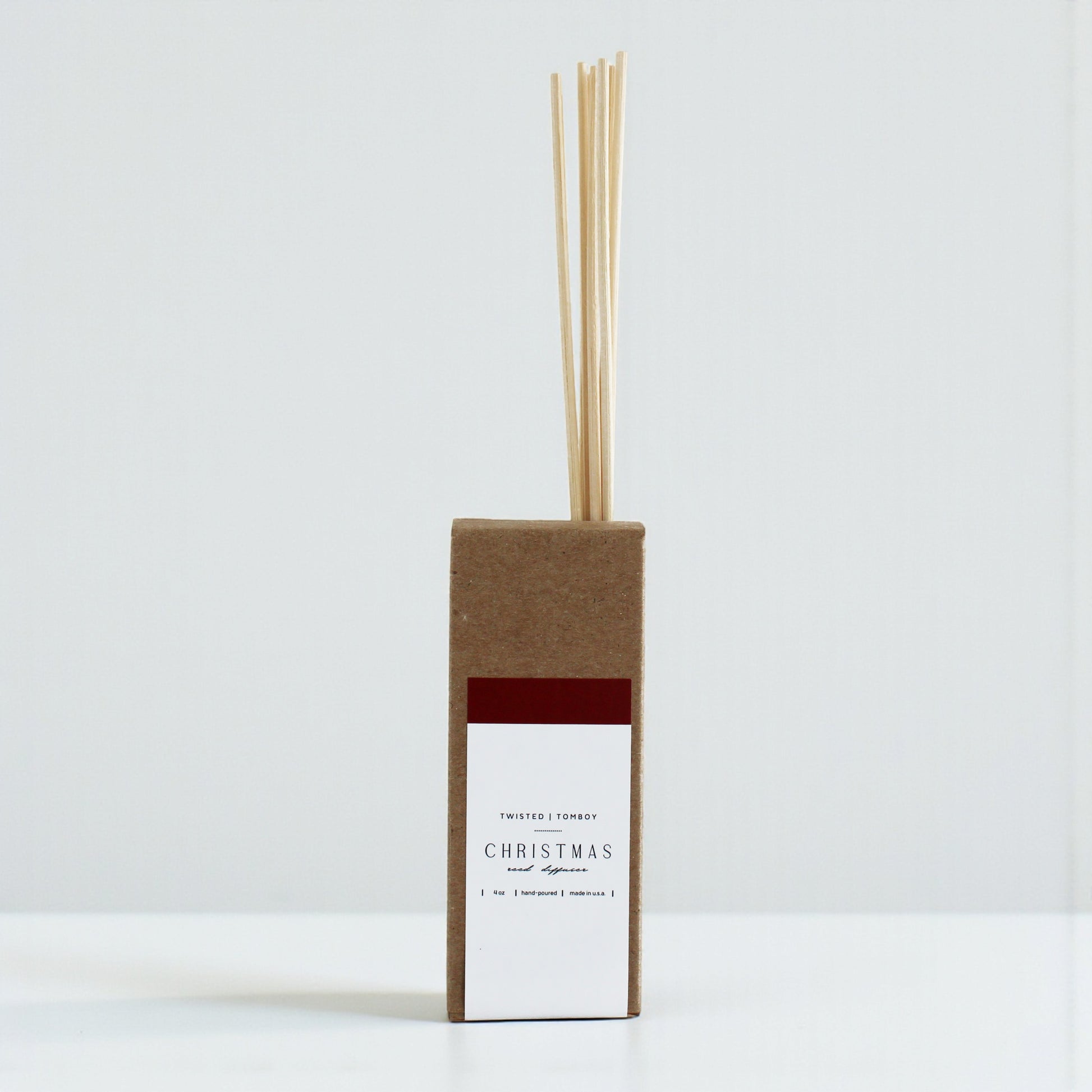 Reed diffusers in six scents, featuring a minimalist brown box design with natural reeds. Perfect for home fragrance.