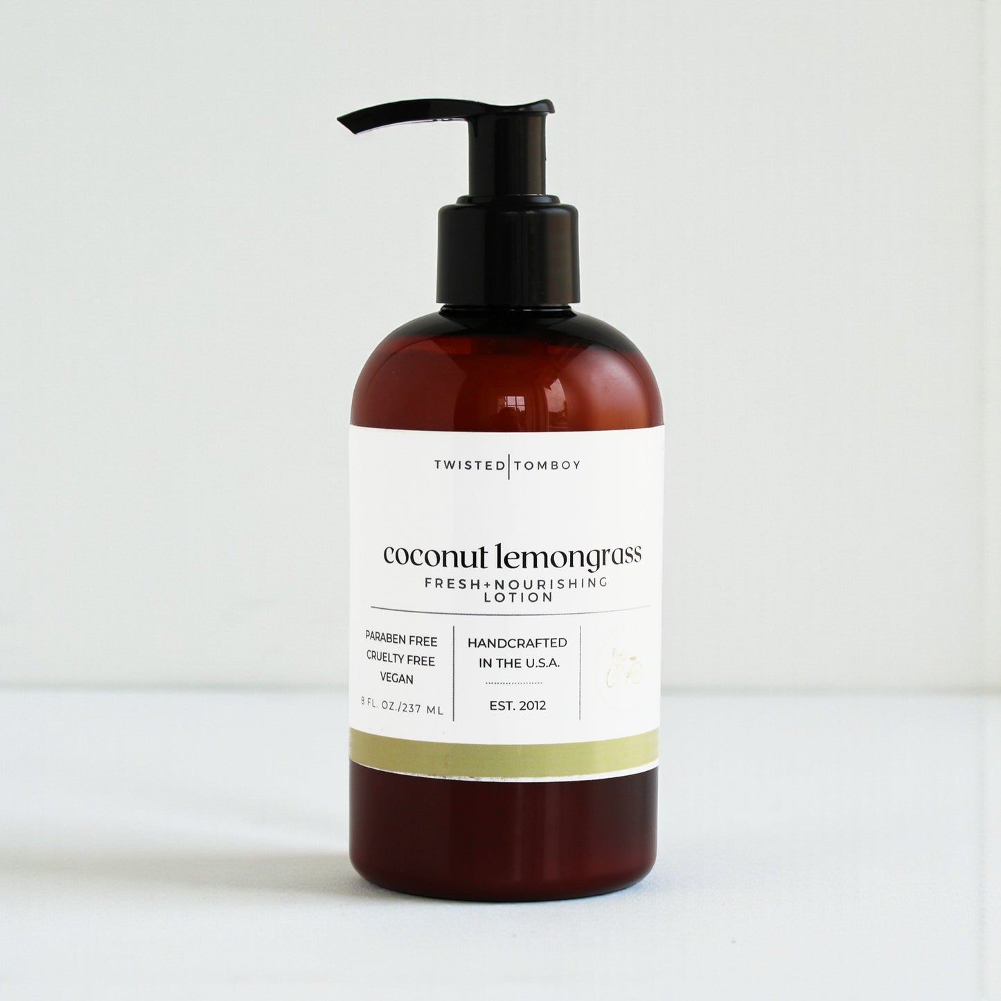 Coconut lemongrass lotion bottle with pump on a white background