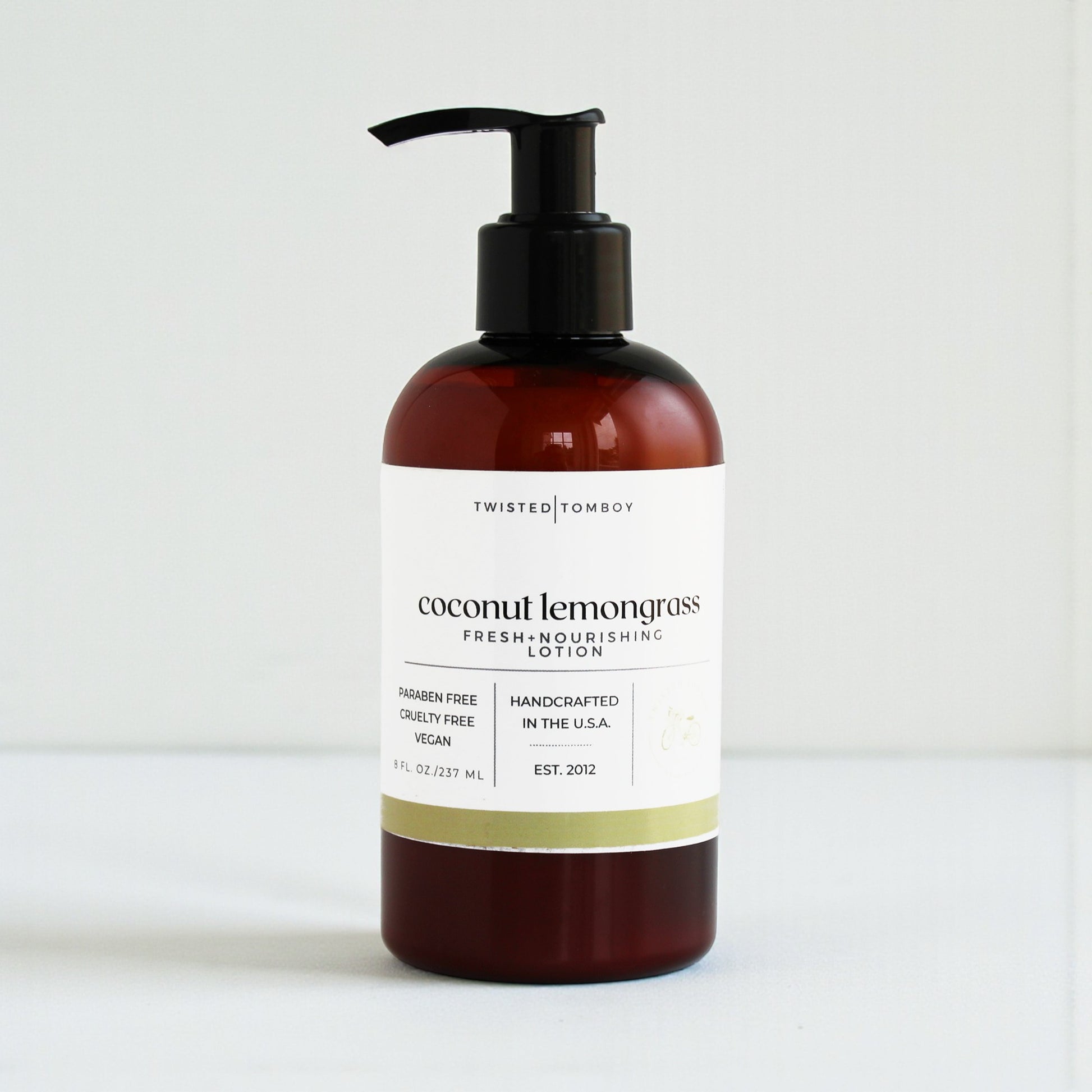 Coconut lemongrass lotion bottle with pump on a white background