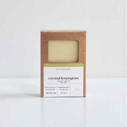 Coconut lemongrass goat milk soap in a brown cardboard box on a white background