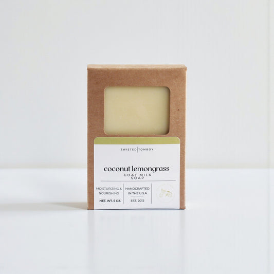 Coconut lemongrass goat milk soap in a brown cardboard box on a white background