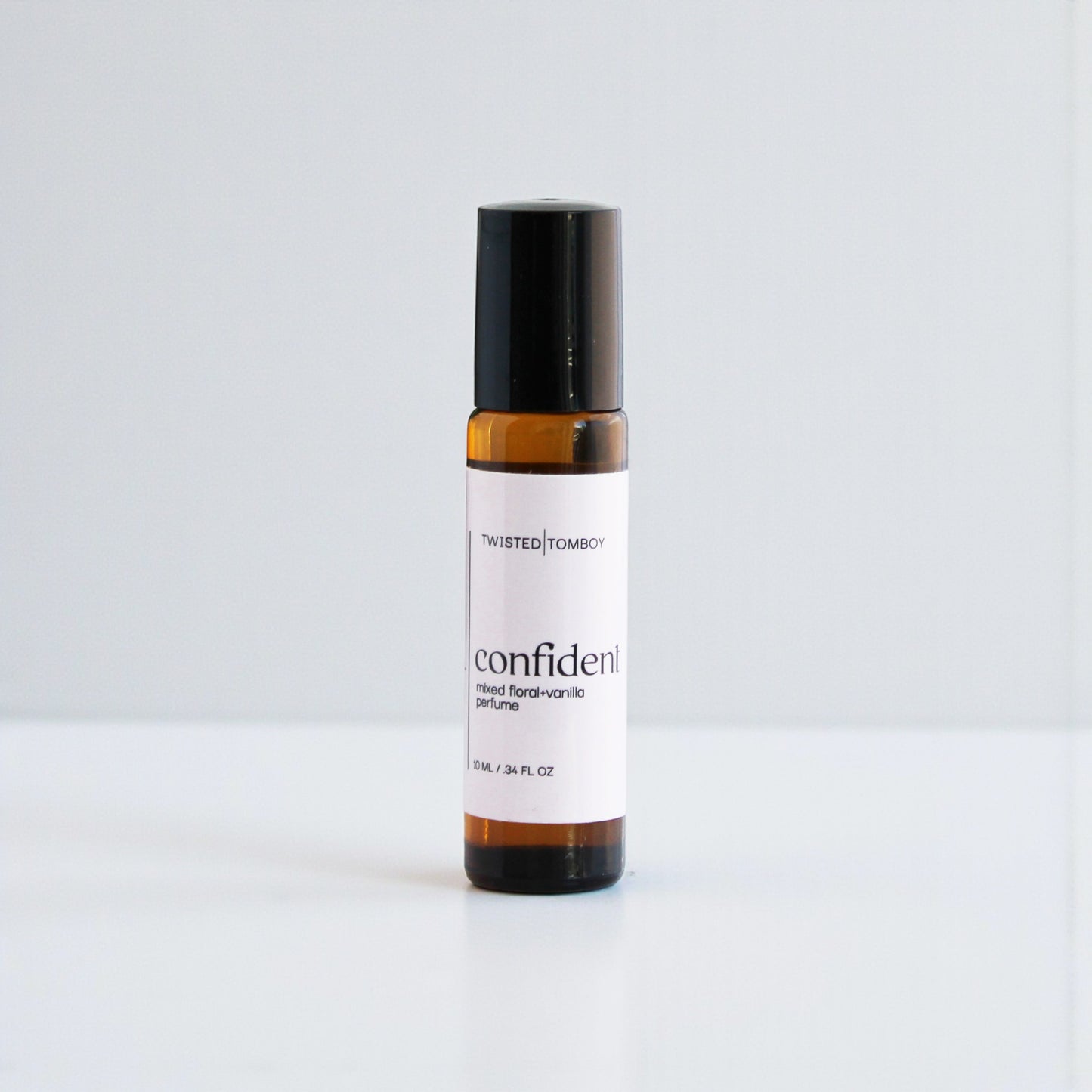 Small bottle labeled 'confident' on a light gray background