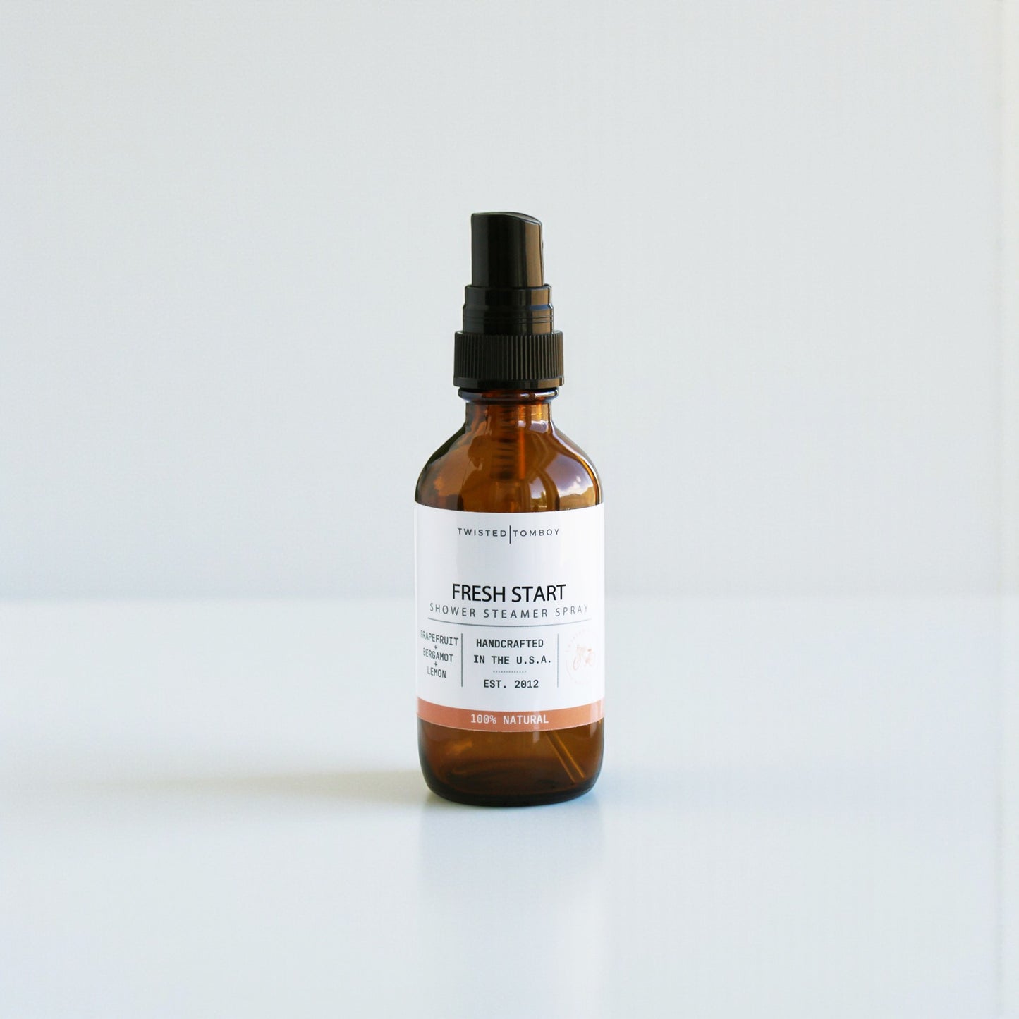 Brown spray bottle labeled 'Fresh Start' on a white background