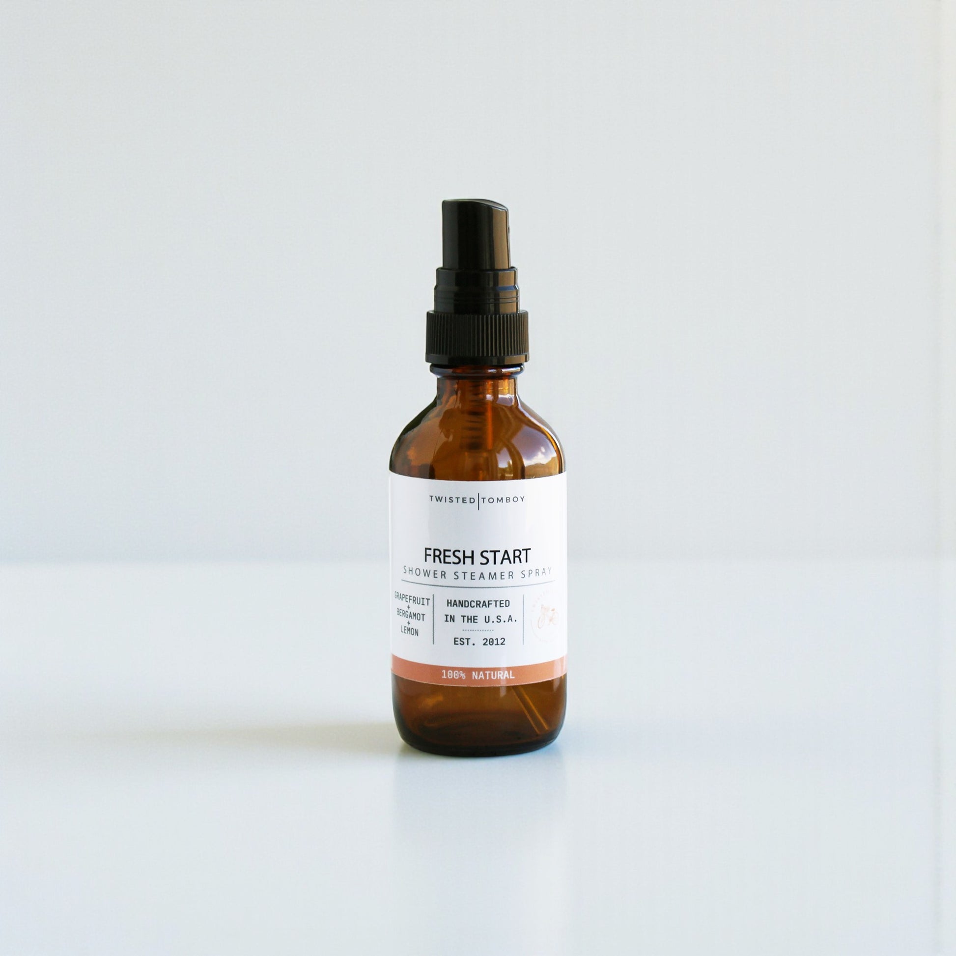 Brown spray bottle labeled 'Fresh Start' on a white background