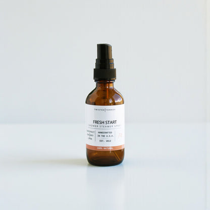 Brown spray bottle labeled 'Fresh Start' on a white background