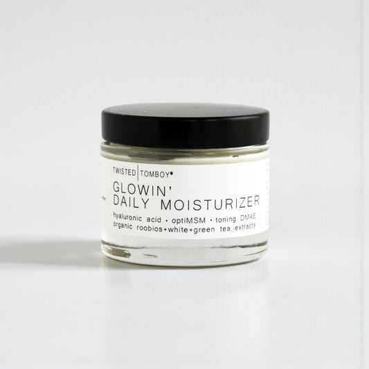 Jar of 'Glowin' Daily Moisturizer' by Twisted Tomboy on a white background