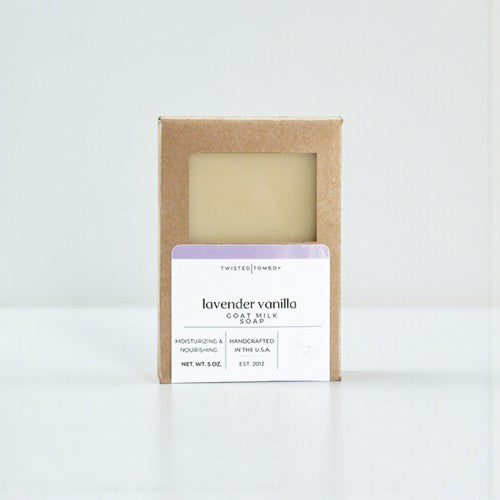 Lavender vanilla goat milk soap in a cardboard box on a white background