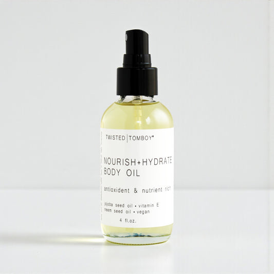 Bottle of Twisted Tomboy Nourish + Hydrate Body Oil on a white background