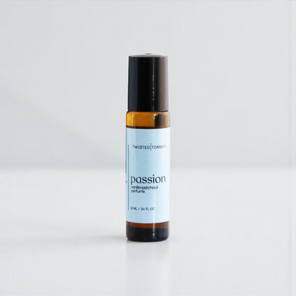 Small perfume bottle labeled 'passion' by Twisted Tommy on a white background