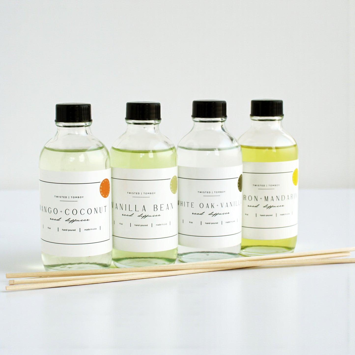 Reed diffusers in six scents including Mango-Coconut, Vanilla Bean, White Oak, and Iron-Mandarin with natural reeds.