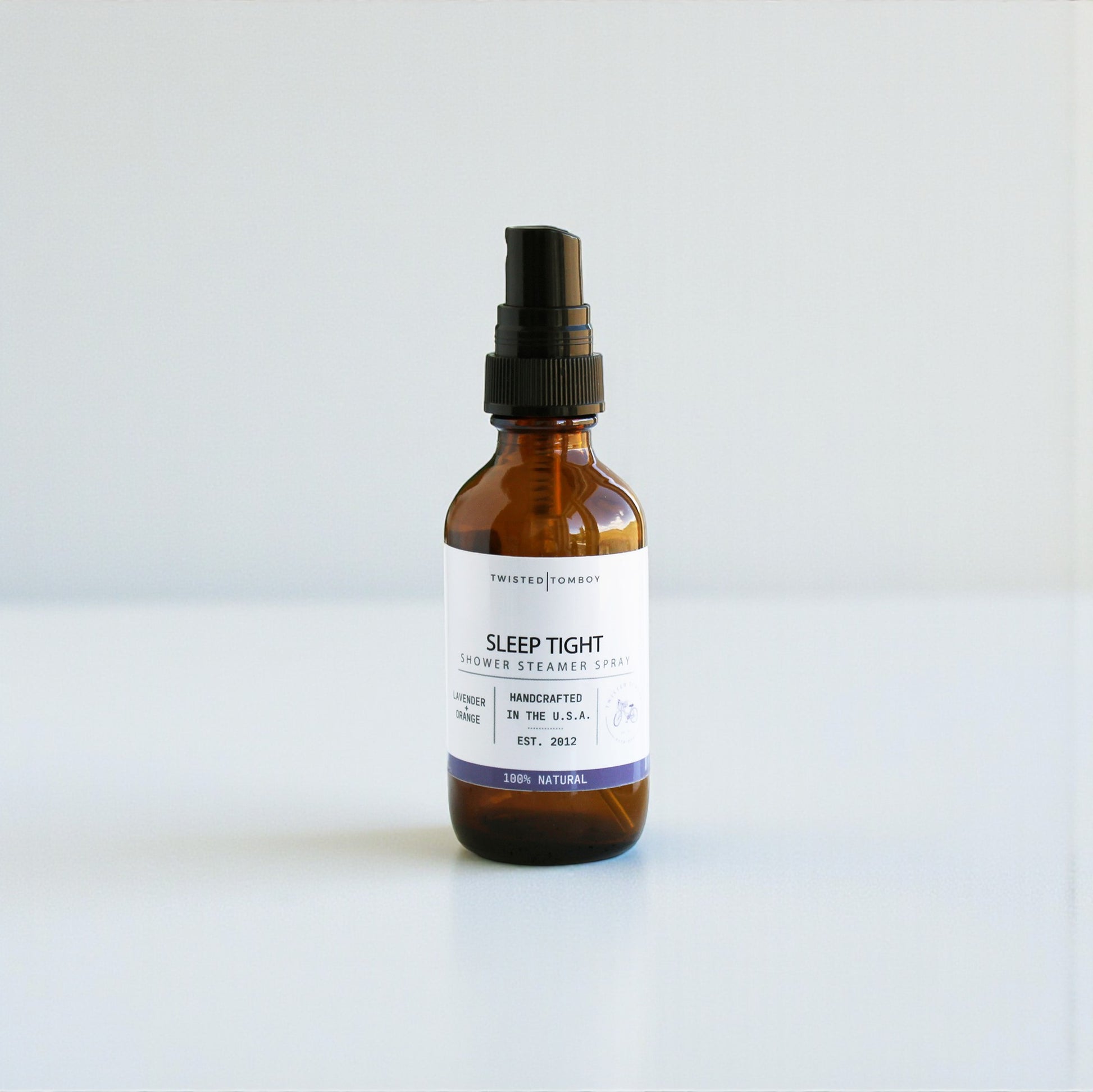 Brown glass bottle with a black spray nozzle on a white background, Sleep Tight