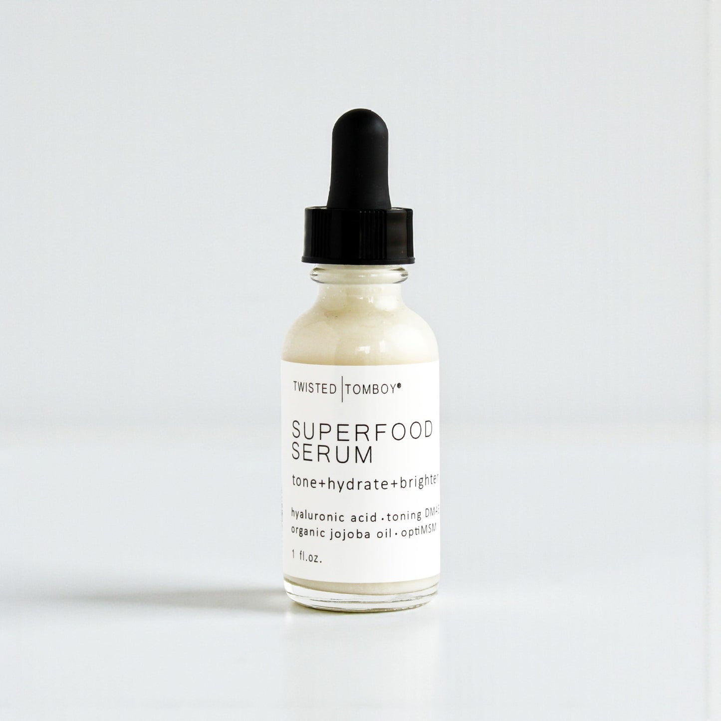 Superfood serum bottle with dropper on a white background