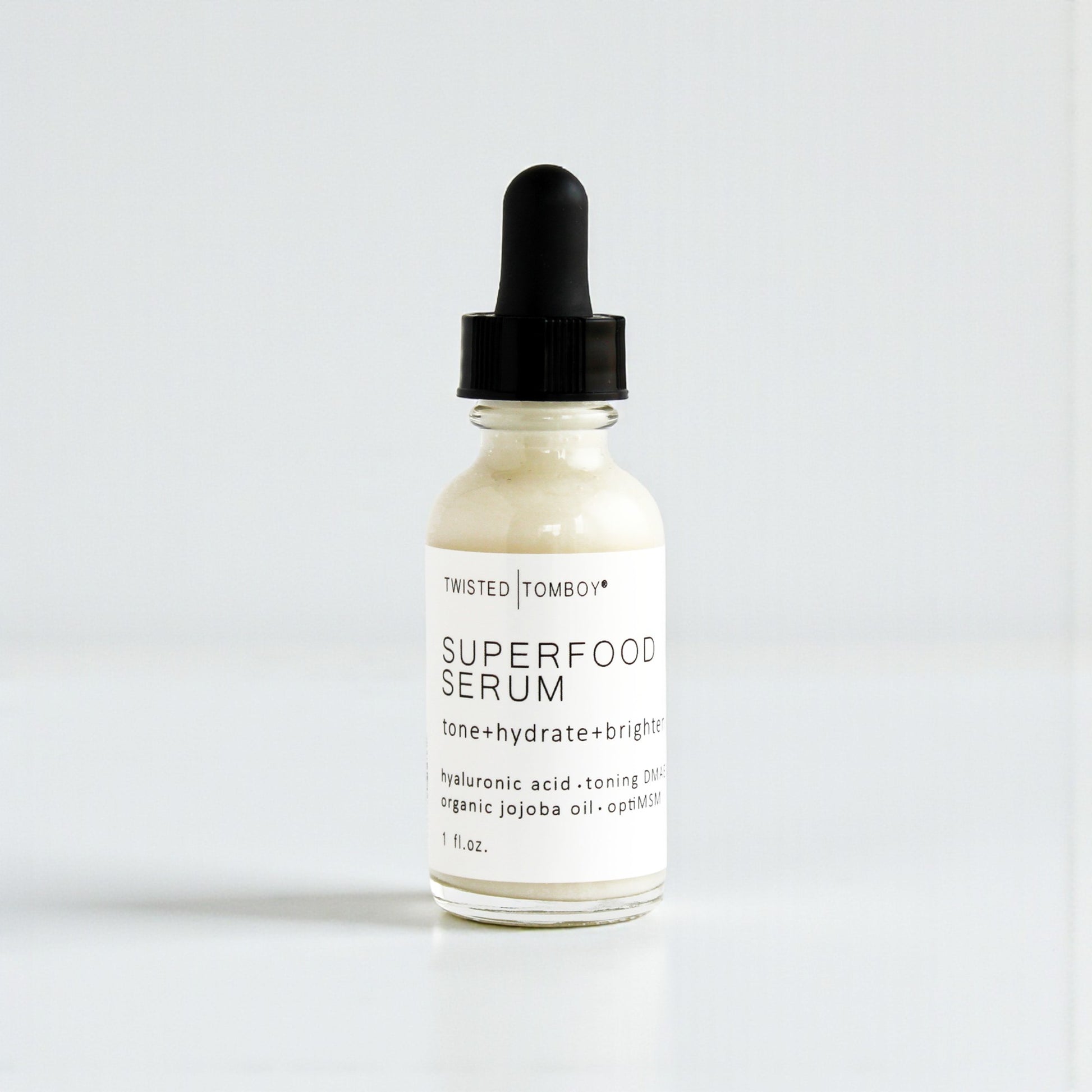 Superfood serum bottle with dropper on a white background
