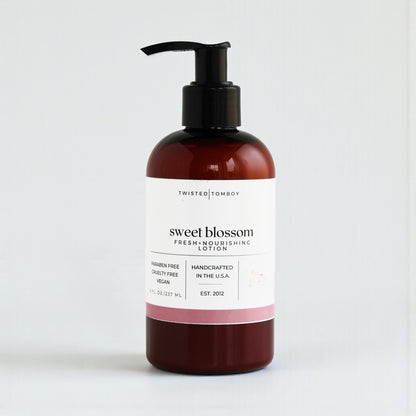 Lotion bottle labeled 'sweet blossom' by Twisted Tomboy on a white background