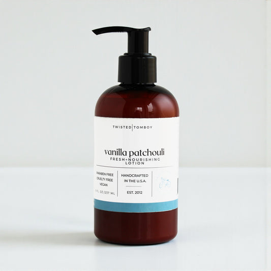Hand cream bottle with pump labeled 'vanilla patchouli' on a white background