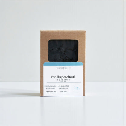 Vanilla patchouli goat milk soap in a brown cardboard box on a white background