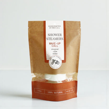 Package of shower steamers labeled 'Wake-Up Call' with a brown and white design on a white background.