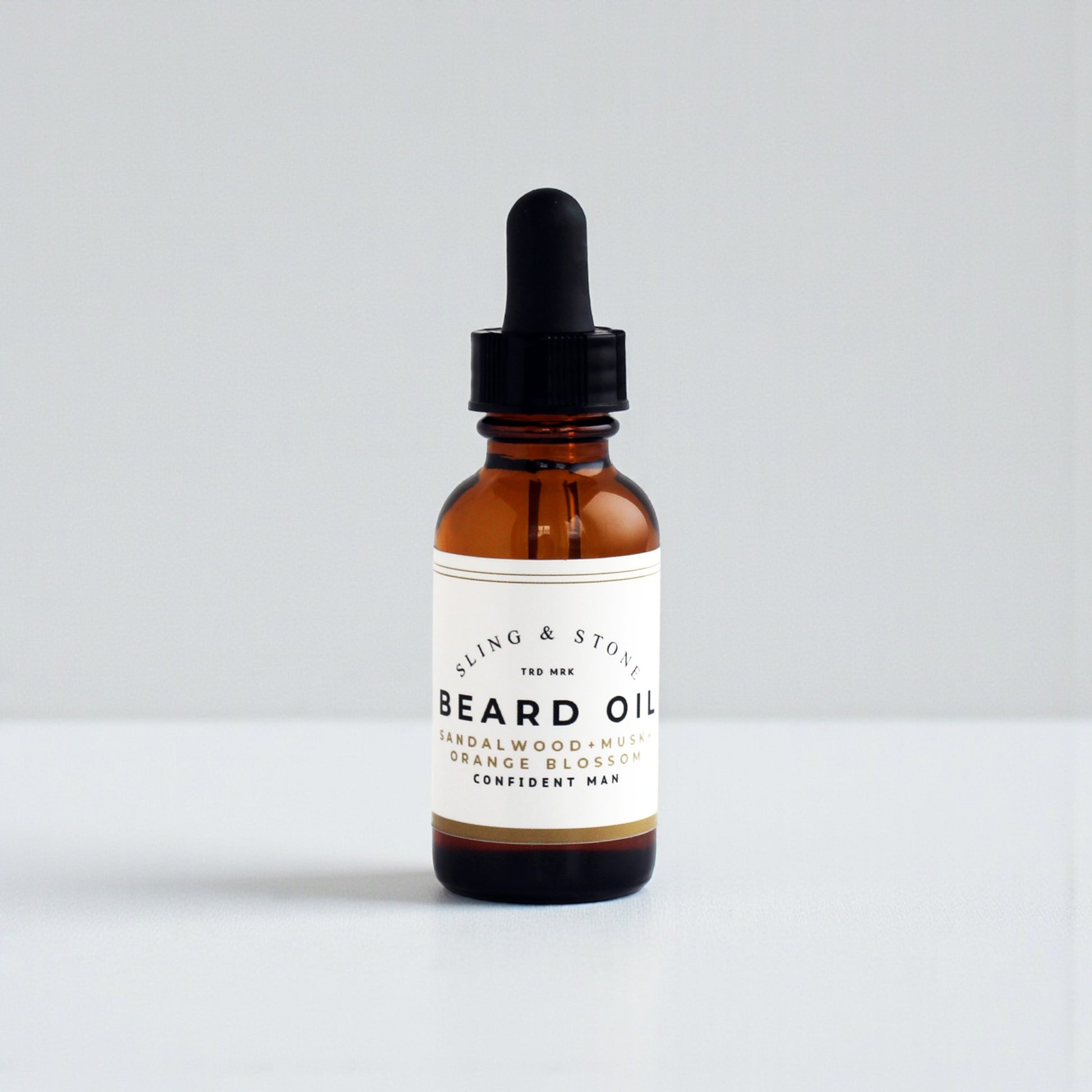 BEARD OIL in amber glass bottle, featuring sandalwood, musk, and orange blossom scents for a confident man.