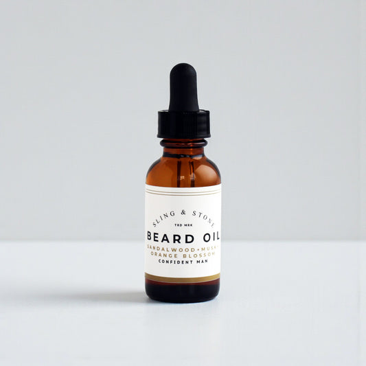 BEARD OIL in amber glass bottle, featuring sandalwood, musk, and orange blossom scents for a confident man.
