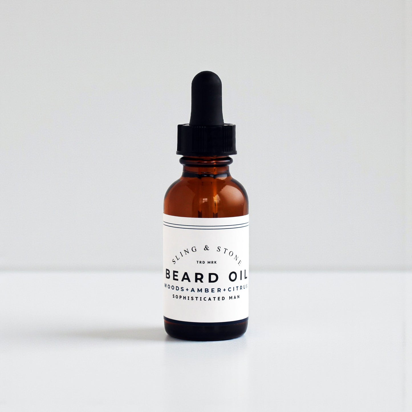 BEARD OIL in amber glass bottle, featuring a 5-oil blend with new scents for the sophisticated man.