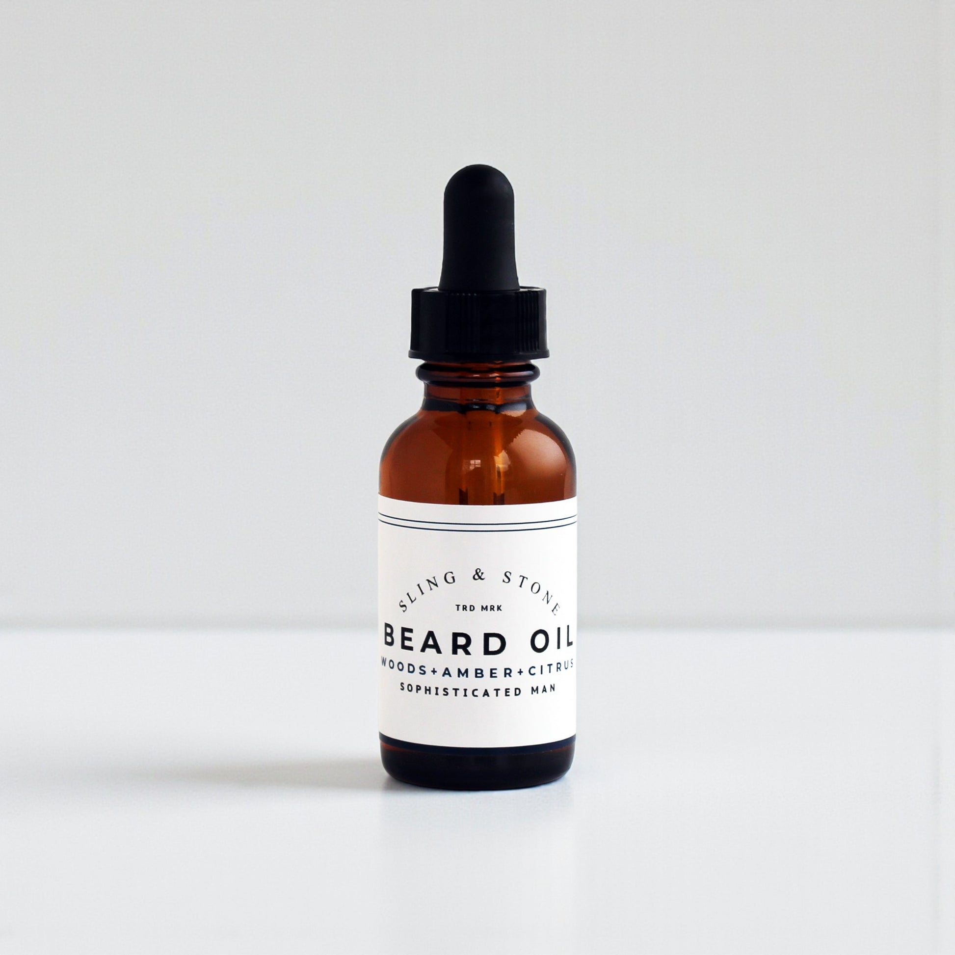 BEARD OIL in amber glass bottle, featuring a 5-oil blend with new scents for the sophisticated man.