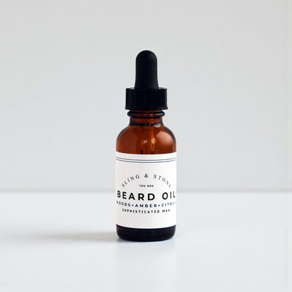 BEARD OIL in amber glass bottle, featuring a 5-oil blend with new scents for the sophisticated man.