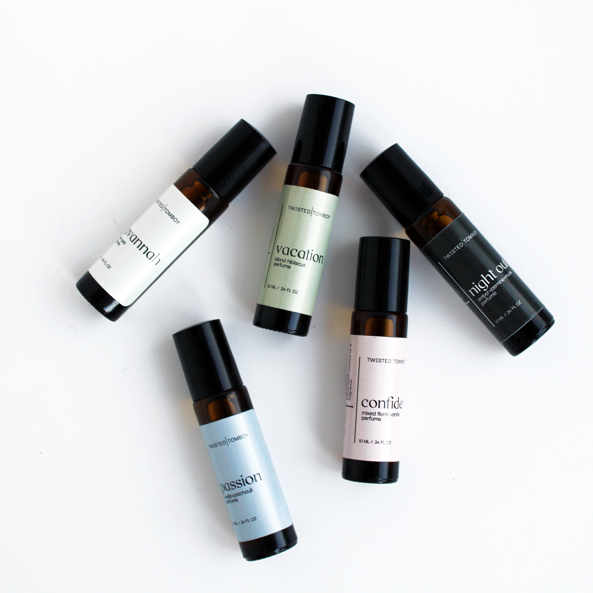 ROLL-ON PERFUMES in five scents: passion, vacation, midnight, confide, and a floral scent in sleek black and brown bottles.
