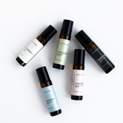 ROLL-ON PERFUMES in five scents: passion, vacation, midnight, confide, and a floral scent in sleek black and brown bottles.