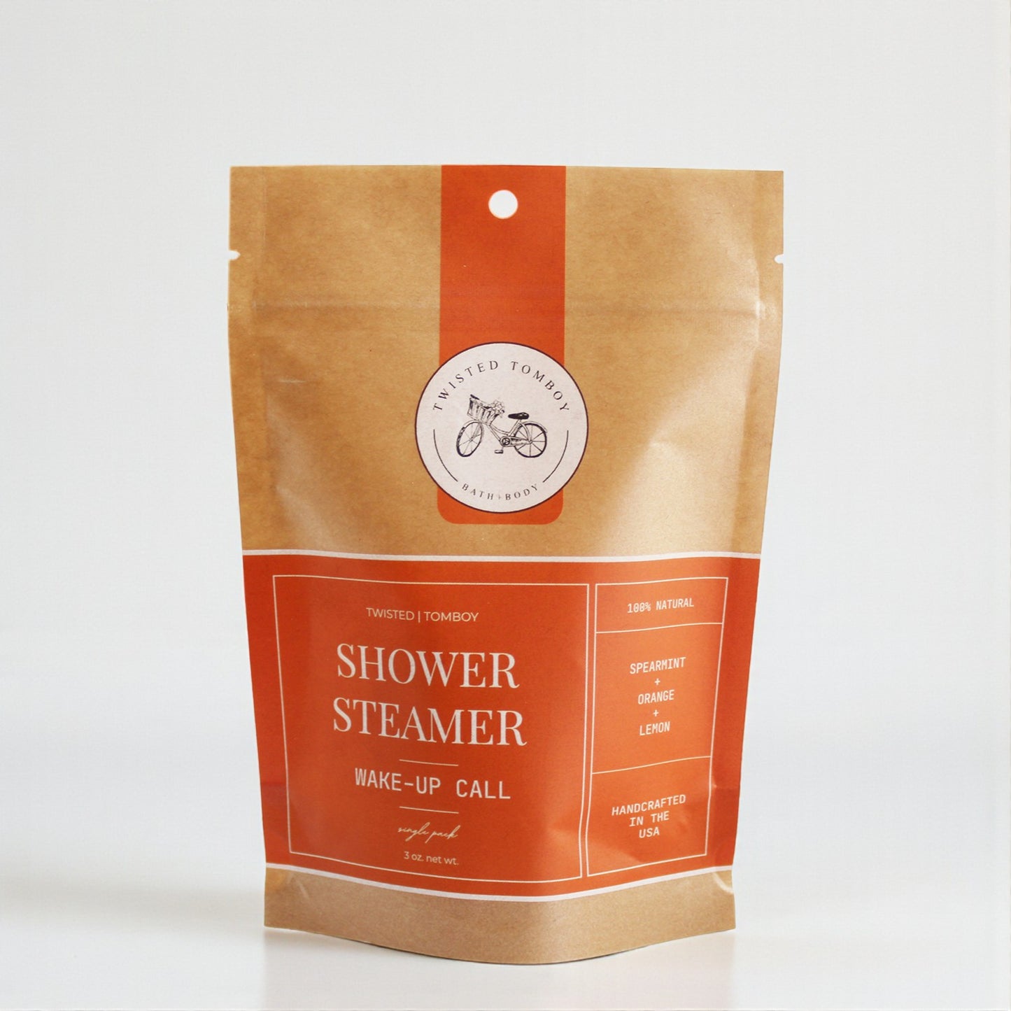 Shower Steamer SINGLES in a kraft paper pouch with orange accents, featuring a spearmint, orange, and lemon scent.