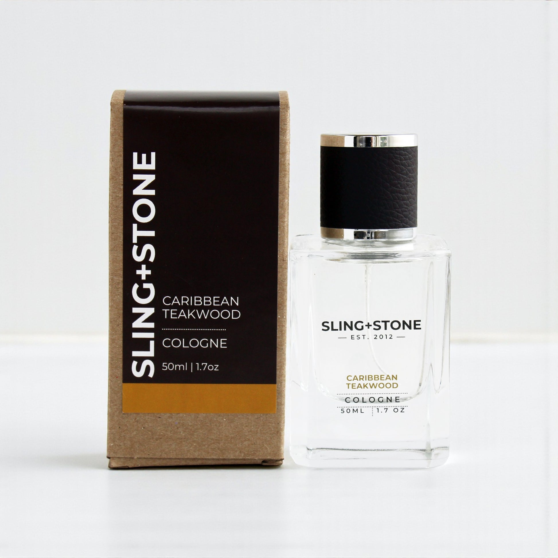FOR HIM | COLOGNE in a clear bottle with a black cap, featuring Caribbean Teakwood scent, packaged in a brown box.