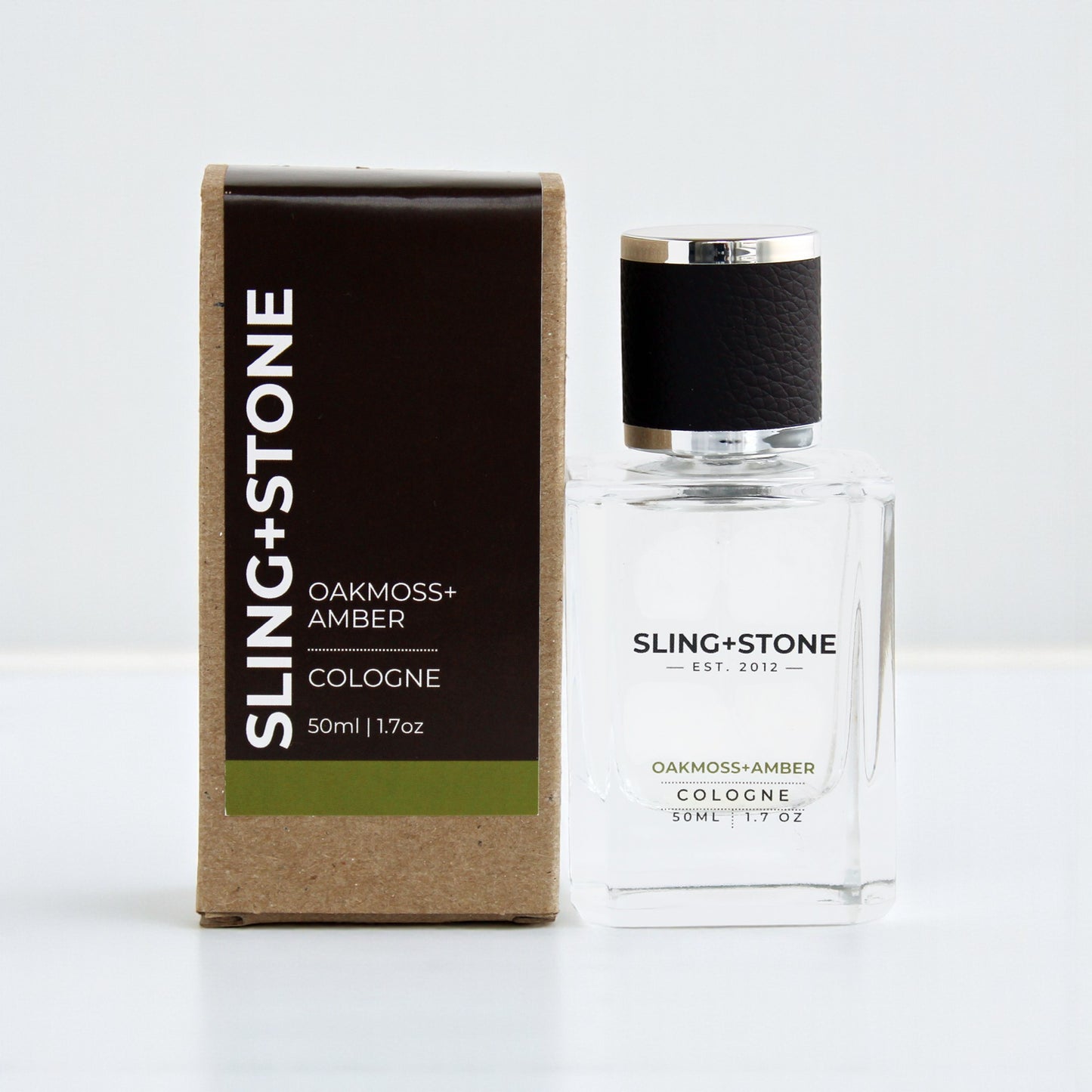 FOR HIM | COLOGNE in a clear glass bottle with a black cap, featuring Oakmoss + Amber scent.